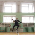 boy kicking the ball in the school gym